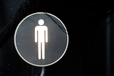 The male gender sign, adorning a clean black wall with minimalist elegance. Close upの写真素材