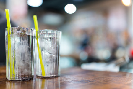 Two glasses of cool water with ice on wood tableの写真素材