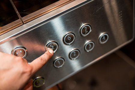 Man hand is pressing elevator button. Close up