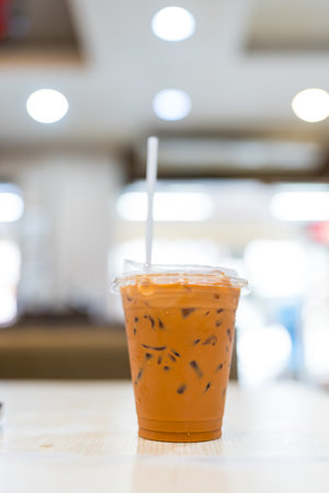 Iced milk tea on plastic cup on tableの写真素材
