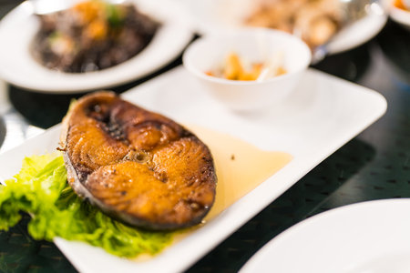 Fried king mackerel with fish sauce served with sweet and sour spicy sauce.の写真素材