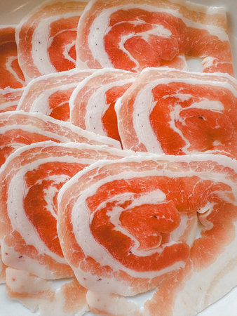 Close up shot of raw pork slices for shabu shabu and sukiyakiの写真素材