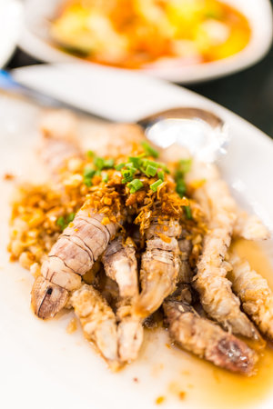 Mantis shrimp stir with garlic served on a white dish, Thai style seafoodの写真素材