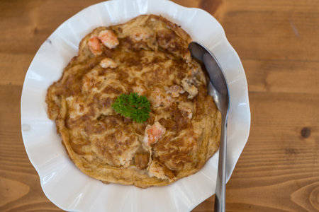 Delicious Thai omelette with shrimp served on white dish. ,Thai call khao kai jeaw  kung