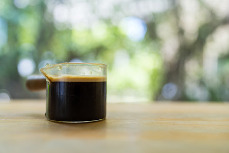 Hot coffee shot espresso roasted arabica menu tasty on wood tableの写真素材