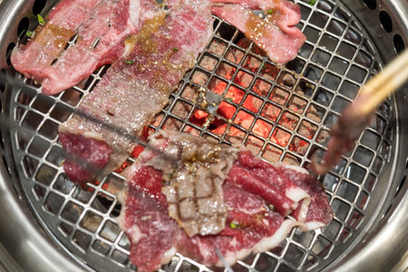 Close up juicy fresh roasted grilled meat beef sliced on charcoal grill at Japanese restaurantの写真素材