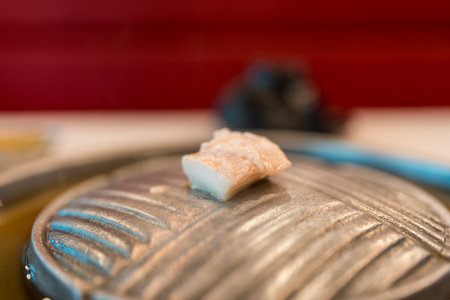 Cube lard meat put on a hot pan is being warmed up for Thai Moo Krataの写真素材