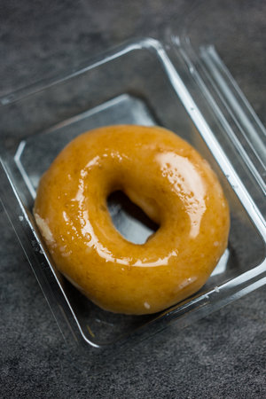 A glazed donut in boxの写真素材