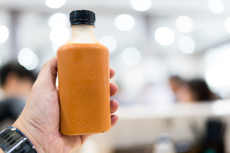 Thai milk tea in plastic bottle, fresh breakfast sweet refreshment