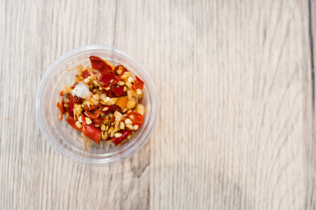 Freshly ground red chilies in mini plastic bowl. Top viewの写真素材