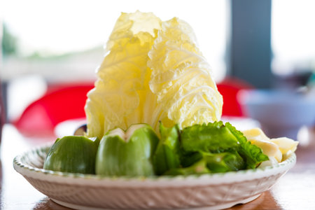 A group of vegetable, fresh lettuce, green eggplant, winged beans served together of many Thai foodの写真素材