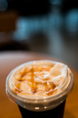 Caramel sauce on milk cream of the beverage. Close up