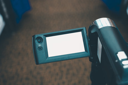 Video camera in conference room recording, white LED display, space for text or pictures.