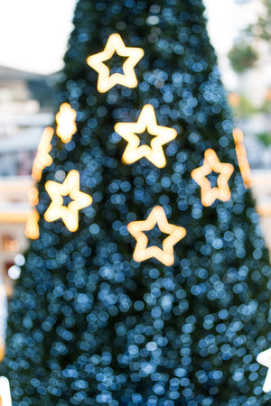Blurred lights star shining amongst Christmas tree. Blurred Christmas tree with sparkleの写真素材