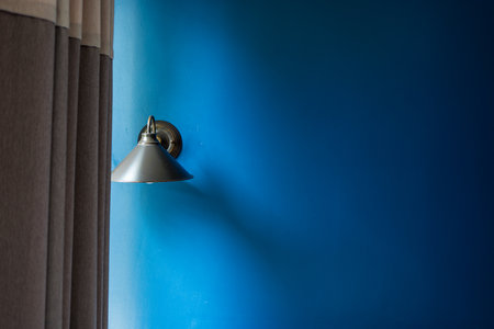 Classic lamp with dark blue tone concrete background wall.