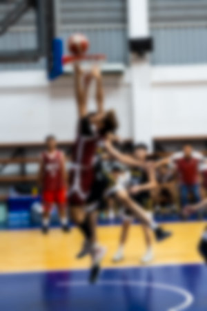 Blurred of basketball player making slam dunkの写真素材