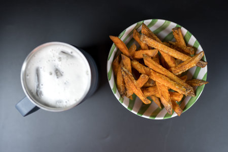 Sweet potato fries swerve with cool beer. Top view