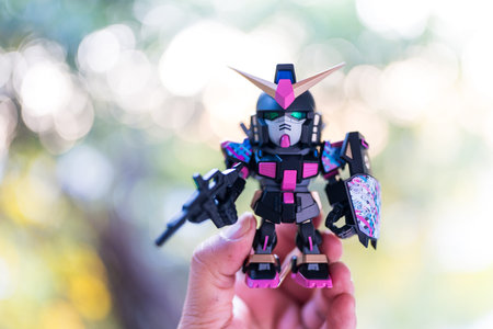 Bangkok, Thailand - February 16, 2026 : ZETA GUNDAM Action Figure - RX-178 GUNDAM MK-II name Giga Omen ver, QMSV MINI Z Gundam & Gundam Mk-II on hand against nature backgroundのeditorial素材