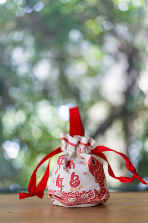 Lucky red Chinese money bag placed on wood tableの写真素材