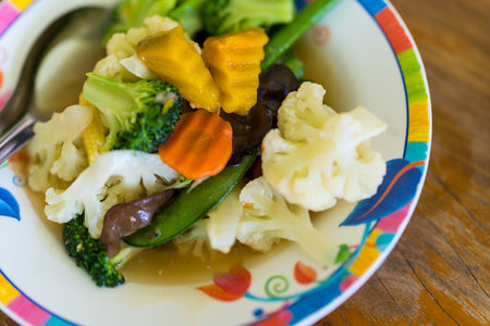 Stir fry vegetables on plate. Vegetarian food, broccoli, mushrooms, corn. Homemade fresh fried vegetables for restaurant, menuの写真素材