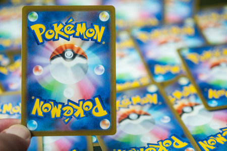 Bangkok, Thailand - April 2, 2026 : A man hand holding Pokemon Trading Card Game, fondness for the...