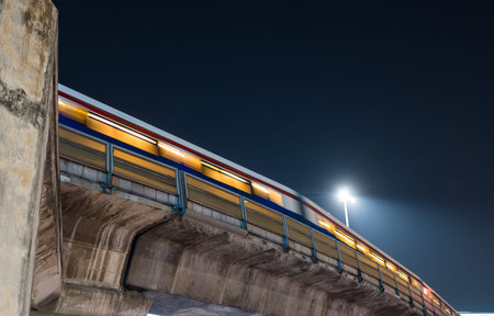 A blurred image of a train at night.
