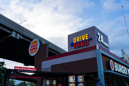 Bangkok, Thailand - July 5, 2026 : Burger King drive-thru restaurant, indicating it is open 24 hours at PTT station in Thailand