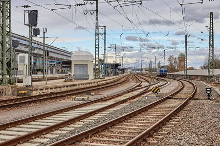 Railway station in Karlsruhe in cloudy weather. A blue locomotive on the rails.の写真素材