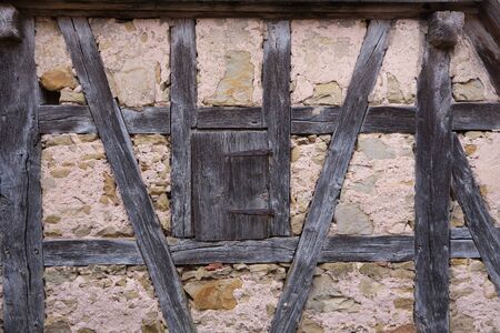 Half-timbered wall with closed hatch on an old house in Rothebnurg, Germany