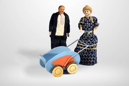 Vintage dolls with stroller, Blond woman in datk dress and man in black suitの写真素材