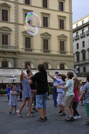 children chasing large bubble, Florence, Italy.のeditorial素材