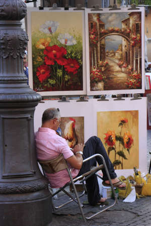 Artist resting near his paintings, Piazza Navona, Rome, Italyのeditorial素材
