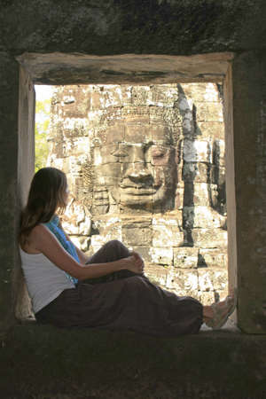 Silhouette of tourist admiring Bayon temple, Angkor area, Siem Reap, Cambodiaの写真素材