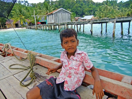 Young boy sitting in a boat, Koh Rong island, Cambodia, Southeast Asiaのeditorial素材