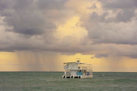 Rainstorm in a sea at sunriseの写真素材