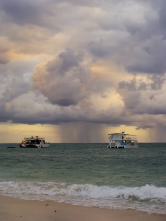 Rainstorm in a sea at sunriseの写真素材