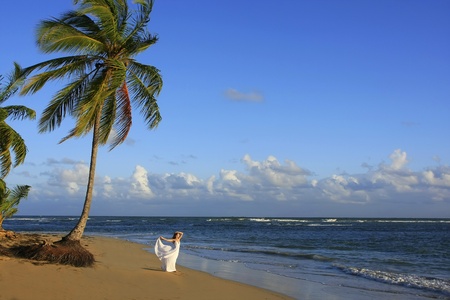 Young woman in white dress on a beachの写真素材