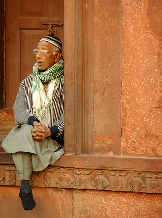 Indian man sitting at Jama Masjid, Delhi, Indiaのeditorial素材