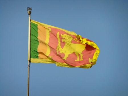 National flag of Sri Lanka against blue sky