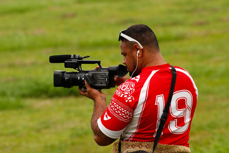 Tongan man taking video of Fuifui Moimoi arriving on Vavau island, Tonga