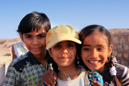 Group of local kids playing near water reservoir, Khichan village, Rajasthan, India