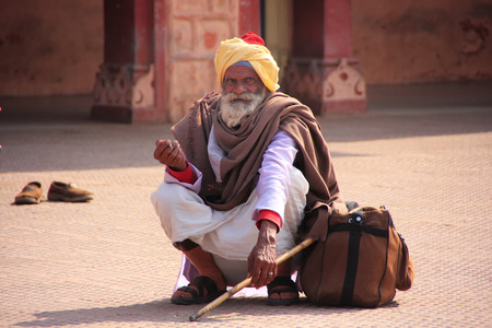 Indian man sitting at train station, Sawai Madhopur, Rajasthan, Indiaのeditorial素材