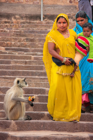 Indian women in colorful sari with a kid walking down the stairs at Ranthambore Fort, Rajasthan, Indiaのeditorial素材