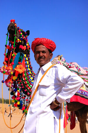 Indian man standing with his decorated camel at Desert Festival, Jaisalmer, Rajasthan, Indiaのeditorial素材