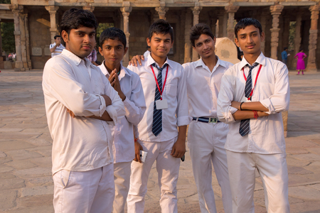 Indian school students standing in the courtyard of Quwwat-Ul-Islam mosque, Qutub Minar complex, Delhi, Indiaのeditorial素材