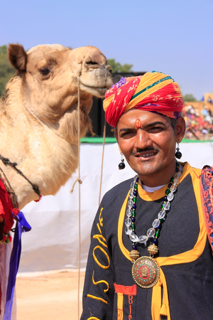 Indian man with a camel taking part in Desert Festival, Jaisalmer, Rajasthan, Indiaのeditorial素材