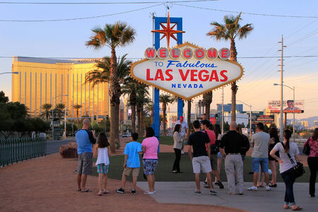 Tourists standing by Welcome to Fabulous Las Vegas sign, Nevada, USAのeditorial素材