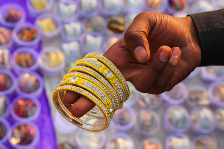Man showing bracelets at the market, Jaipur, Indiaの写真素材