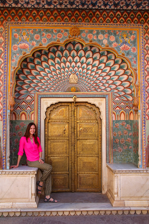 Young woman sitting at Lotus Gate in Pitam Niwas Chowk, Jaipur City Palace, Rajasthan, India. Palace was the seat of the Maharaja of Jaipur, the head of the Kachwaha Rajput clan.のeditorial素材