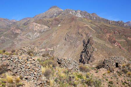 Pre-Incan round houses named colca near Chivay in Peru. Colcas are circular stone structures used for food storage or burials.の写真素材